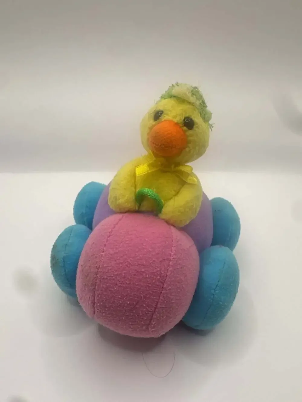 Vintage Pull-Back Toy Chick Driving a Multi-Colored Plush Bumper Car